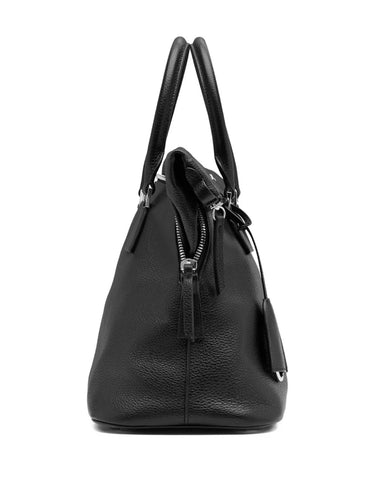 Maison Margiela 5AC Soft Medium in black, side view, structured silhouette with side zip compartment and leather tassel detail