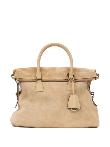 Front view of the Maison Margiela 5AC Soft Medium bag in camel sand-tone suede, featuring two leather top handles, a zippered main compartment, and the signature 5AC structure.