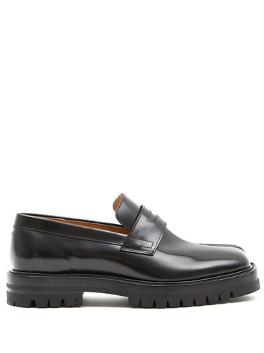 Black leather loafer shoe on a white background