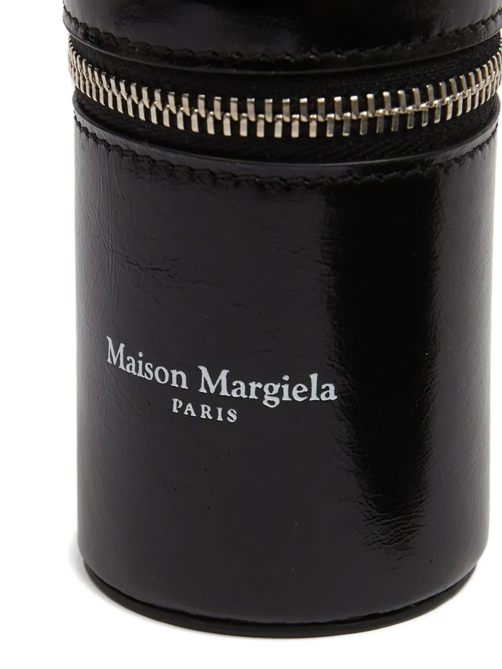 Detail close-up of the Maison Margiela Dog Waste Bag Dispenser in black leather, featuring the white printed brand logo on the front.