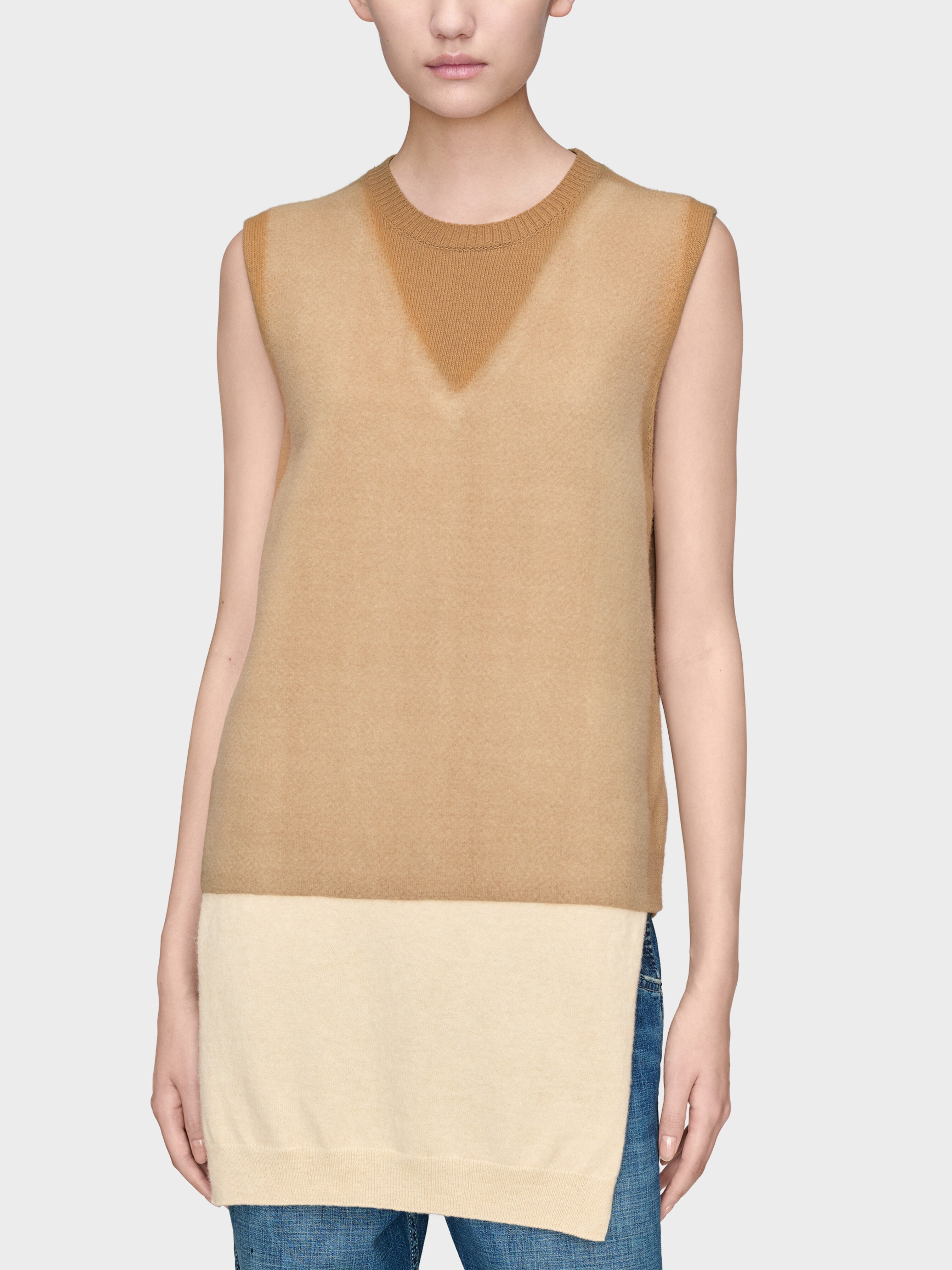 Model wearing Maison Margiela Fuse Knit Top in camel ecru with elongated sleeveless shape and layered colour-block knit design