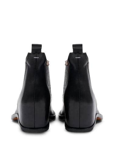 Maison Margiela Heel-Less Western Chelsea Boot 45mm, rear view of both boots highlighting the leather pull tab, back seam, Margiela stitch pin detail, and angular heel-less construction