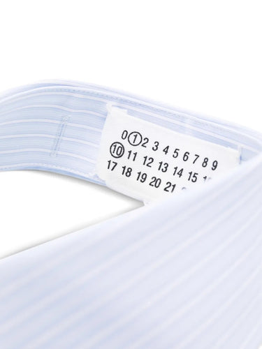 Close-up of a size label on a white collar with a white background