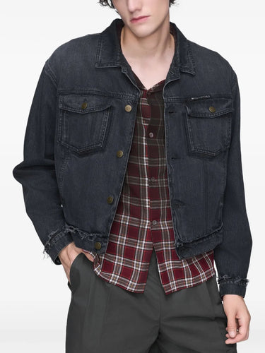 Close-up front view of the model wearing the Maison Margiela sports jacket, highlighting the washed black denim, collar detail, and button closure.