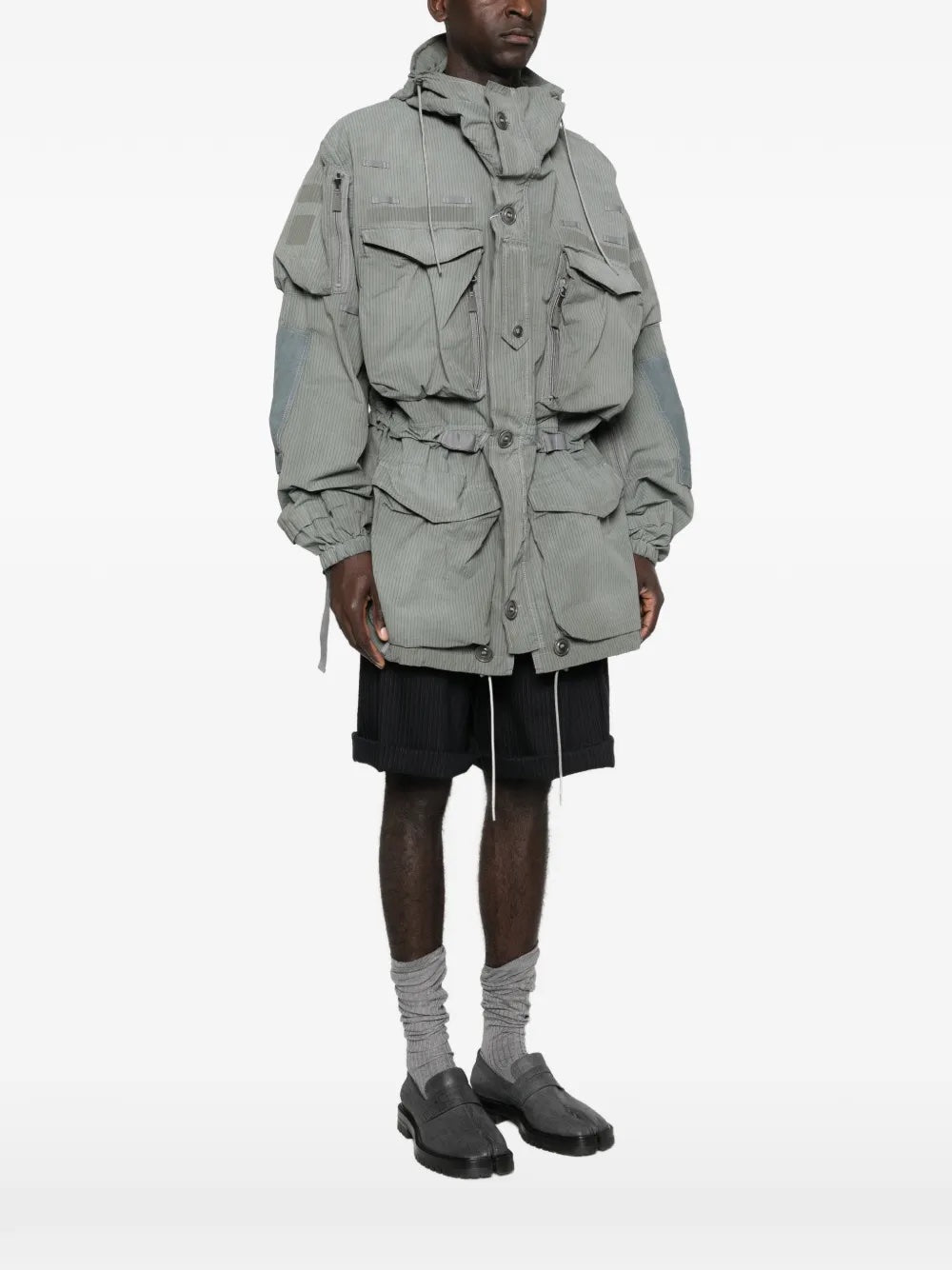Side view of a model wearing the Men's Sports Jacket in Sage from Maison Margiela