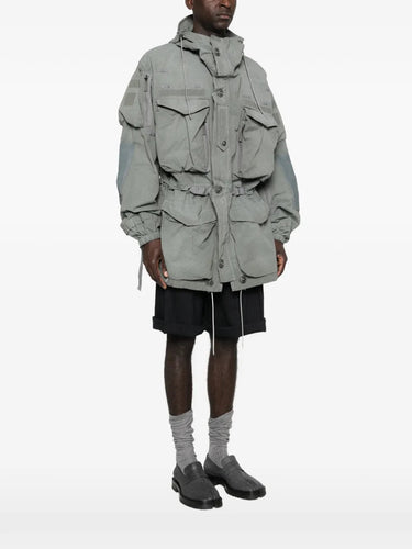 Side view of a model wearing the Men's Sports Jacket in Sage from Maison Margiela