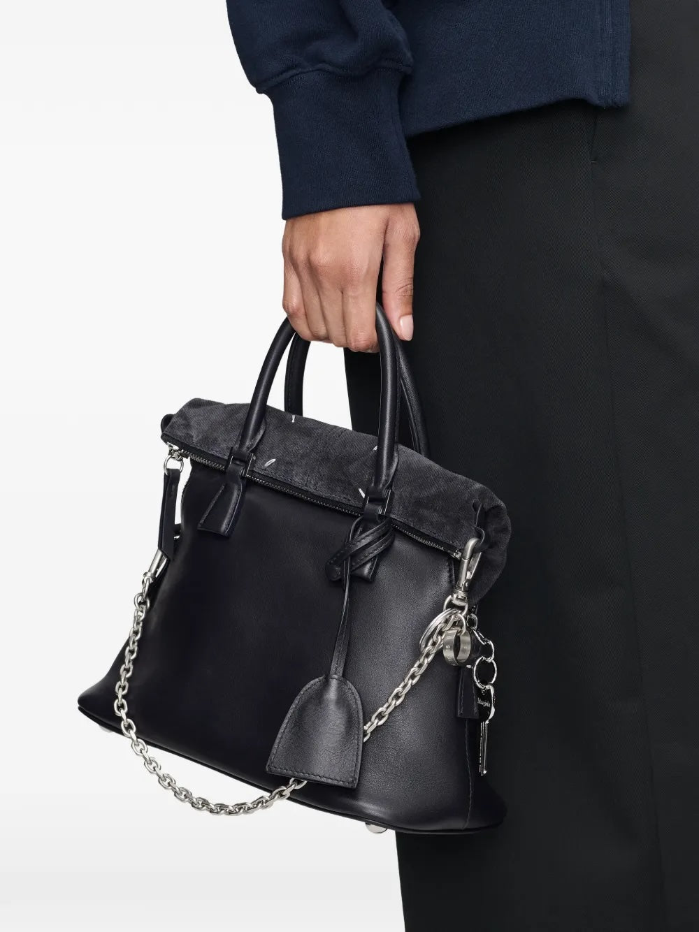Maison Margiela Numeric Bag Chain attached to a black leather bag as a shoulder strap, styled with dark tailoring