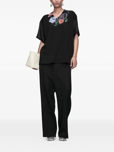 Maison Margiela Painted Floral T-Shirt in black, full length model view, V-neck with painted floral print and satin sleeves