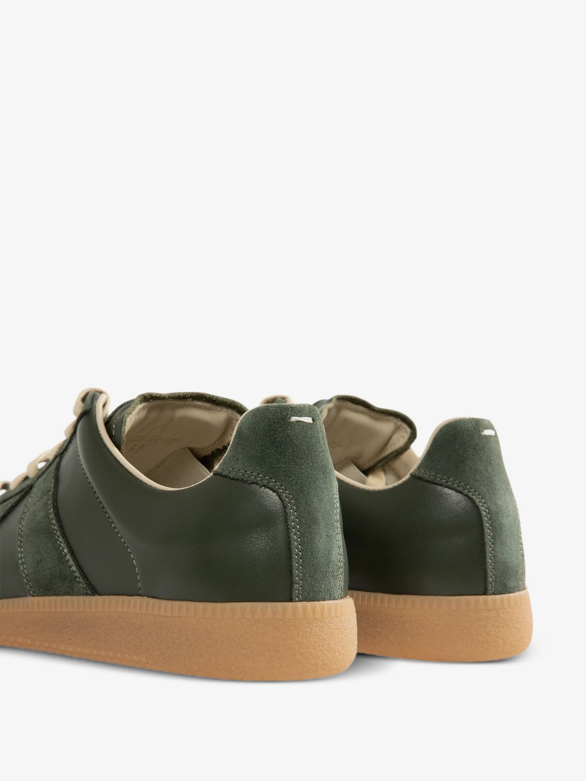 Detail shot of the back of the forest green Replica sneakers from Maison Margiela on a white background