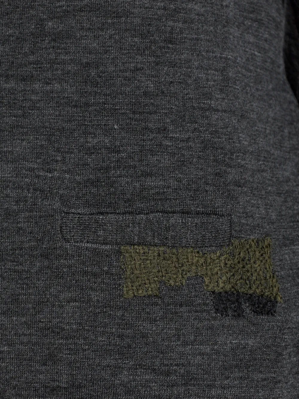 Close-up of the distressed mended detail on the Maison Margiela Mended Cardigan in Grey