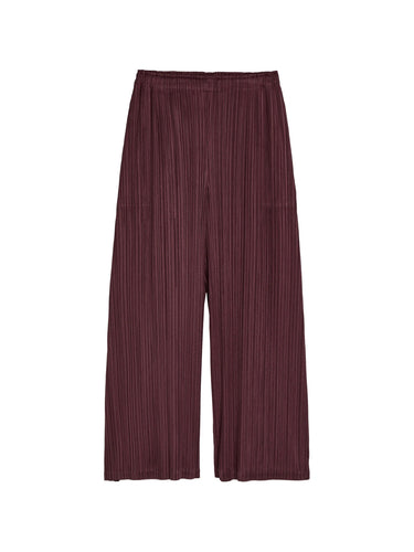 Bordeaux pleated pants from Pleats Please Issey Miyake on a white background