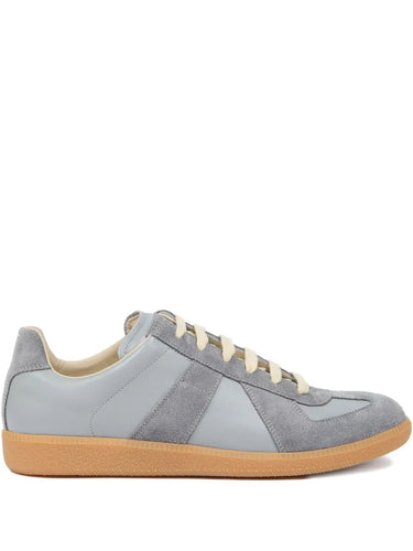 Side packshot of the Maison Margiela Replica Sneakers in Ghost Gray, showing the leather upper with suede panels, lace-up fastening, low-top silhouette, and rubber sole.