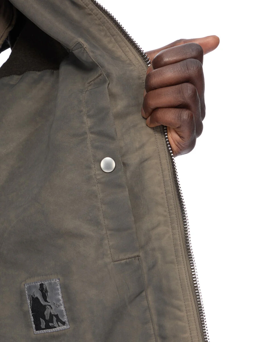Interior detail of the Rick Owens DRKSHDW Jumbo SL Flight Vest in Dark Dust showing the internal snap-fastening pocket and lining.