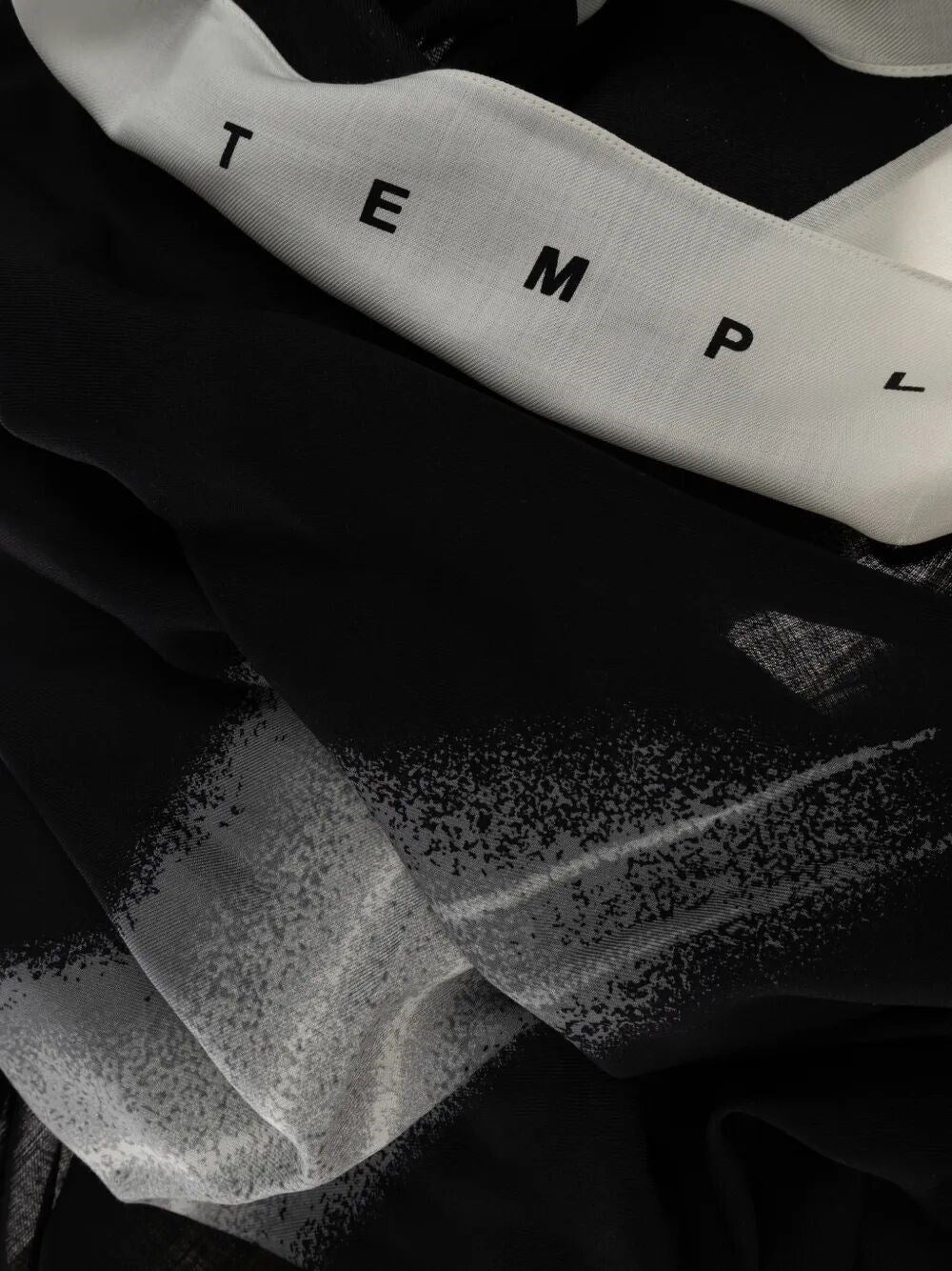 Close-up of Rick Owens DRKSHDW Woven Pashmina Scarf in Milk Black showing the lightweight fabric, graphic print and Temple lettering detail.