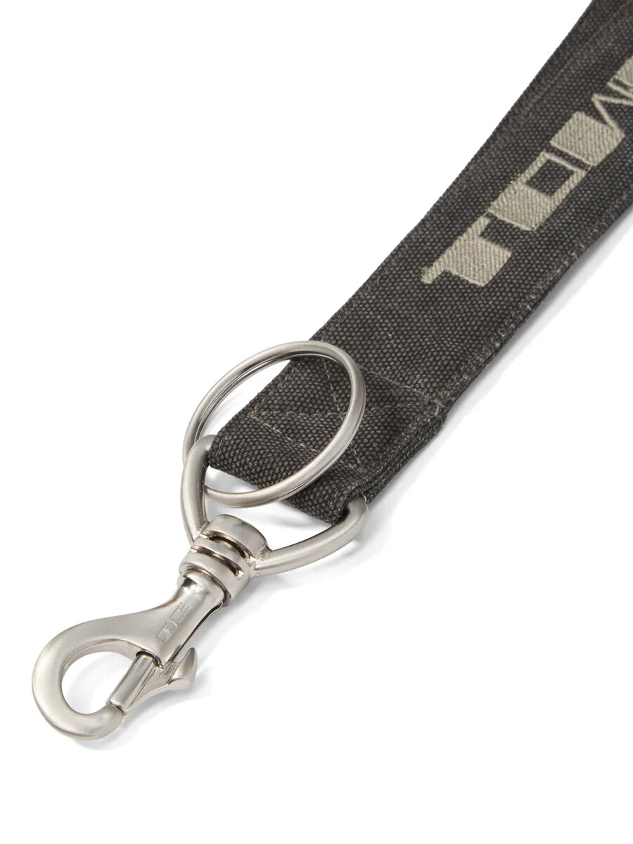 Close-up of Rick Owens Neckhook in Gravel/Pearl showing the embroidered Tower motif, stitching, silver-tone keyring and snap clip.