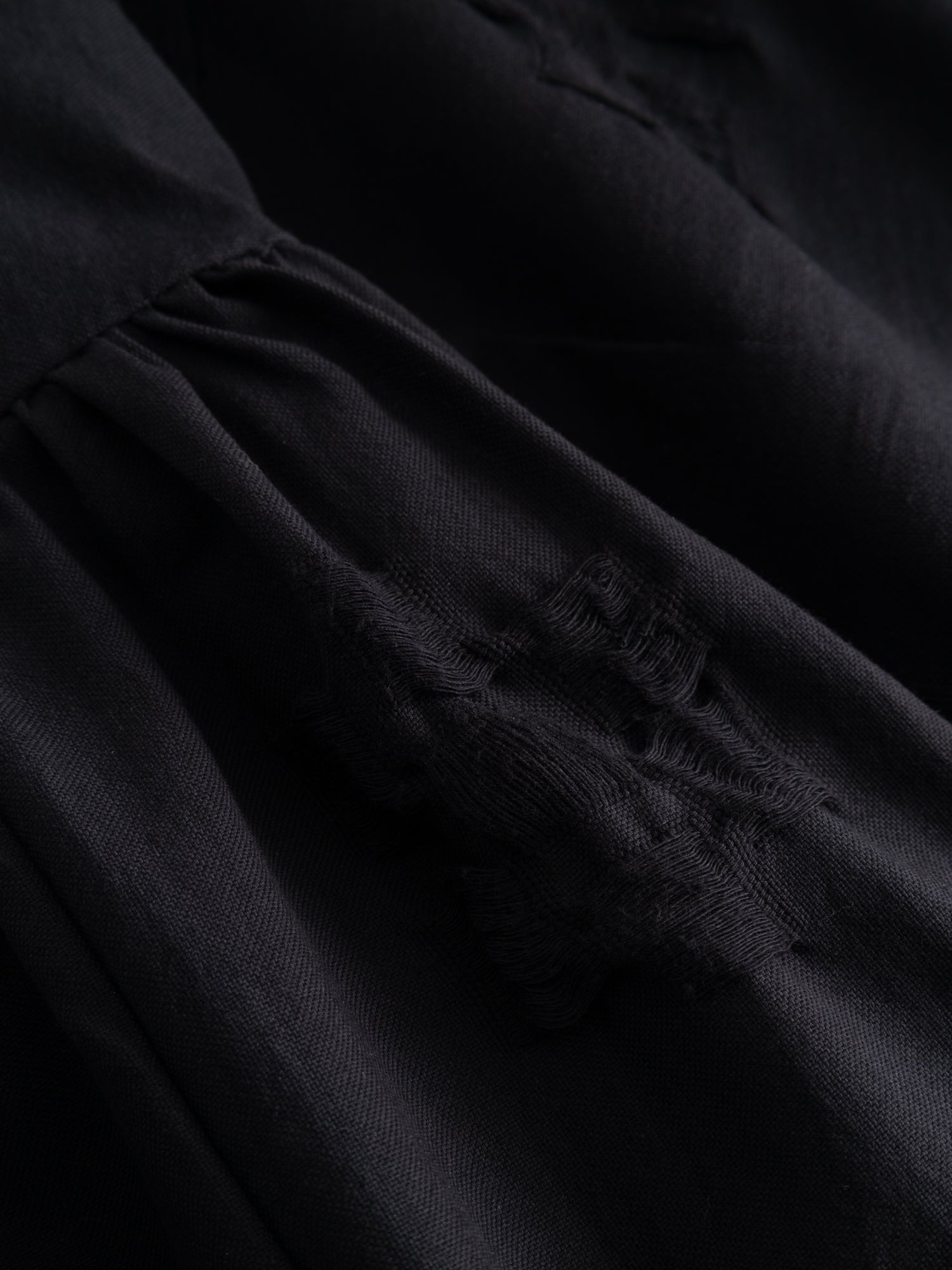 Stem Patchwork Dress in black, close-up of zero-waste patchwork fabric construction and gathered skirt detail