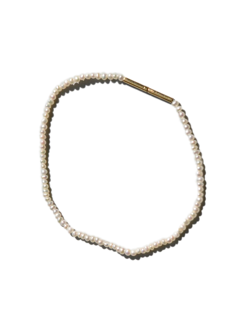 Packshot of the Fine Pearl Bracelet in Gold/Pearl from the Saskia Diez Spring Summer 2026 collection, showing tiny freshwater pearls with a gold clasp.