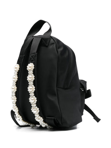 Black backpack with pearl detailing on a white background