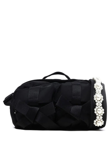 Black shoulder bag with decorative bow and pearl details on a white background
