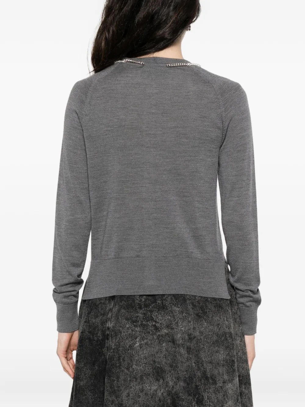 Person wearing a gray long-sleeve cardigan from Simone Rocha on a white background