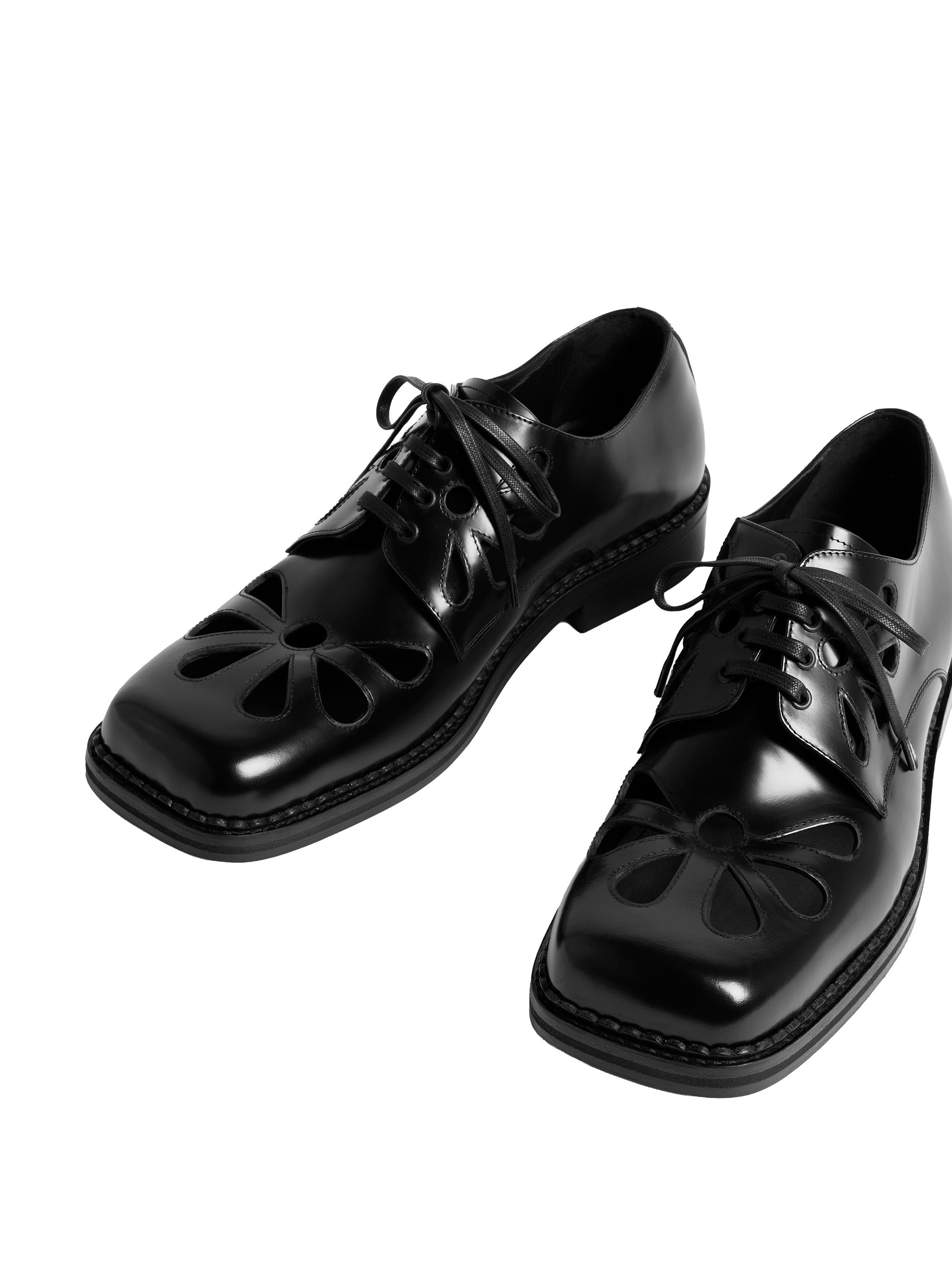 A pair of black derby shoes with daisy cut-out design by Simone Rocha