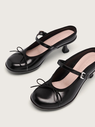 A pair of black heeled mules with grip soles from Simone Rocha