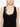 Person wearing a black tank top with a pearl detail on a white background