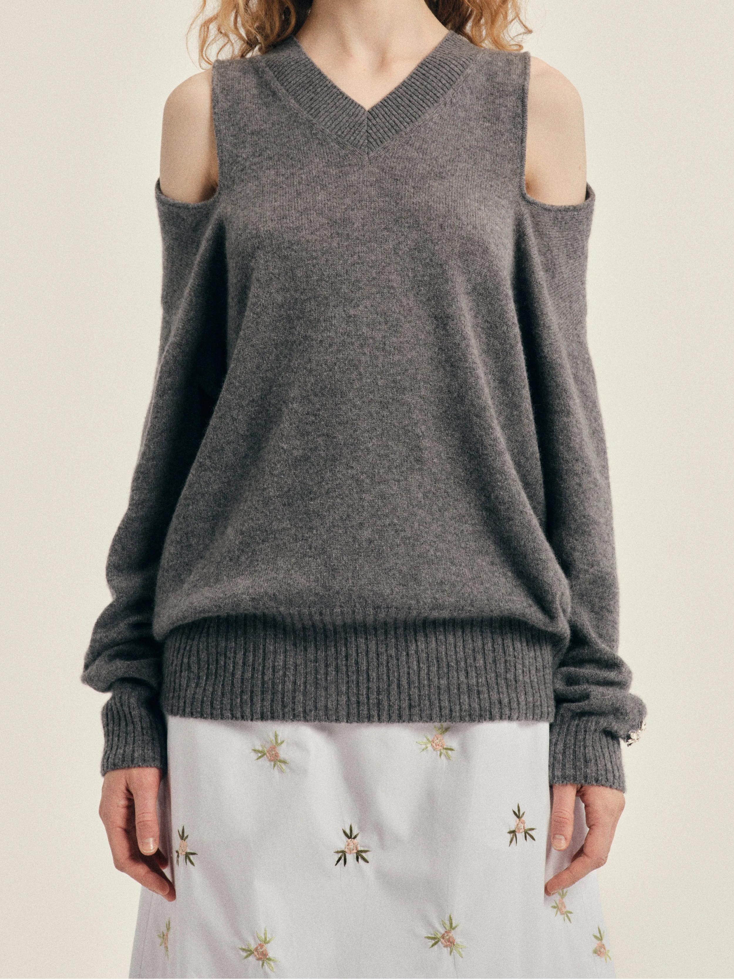 Simone Rocha Relaxed Cashmere Slash V-Neck Jumper With Embellishment in Grey, worn front view with exposed shoulders and relaxed long sleeves.