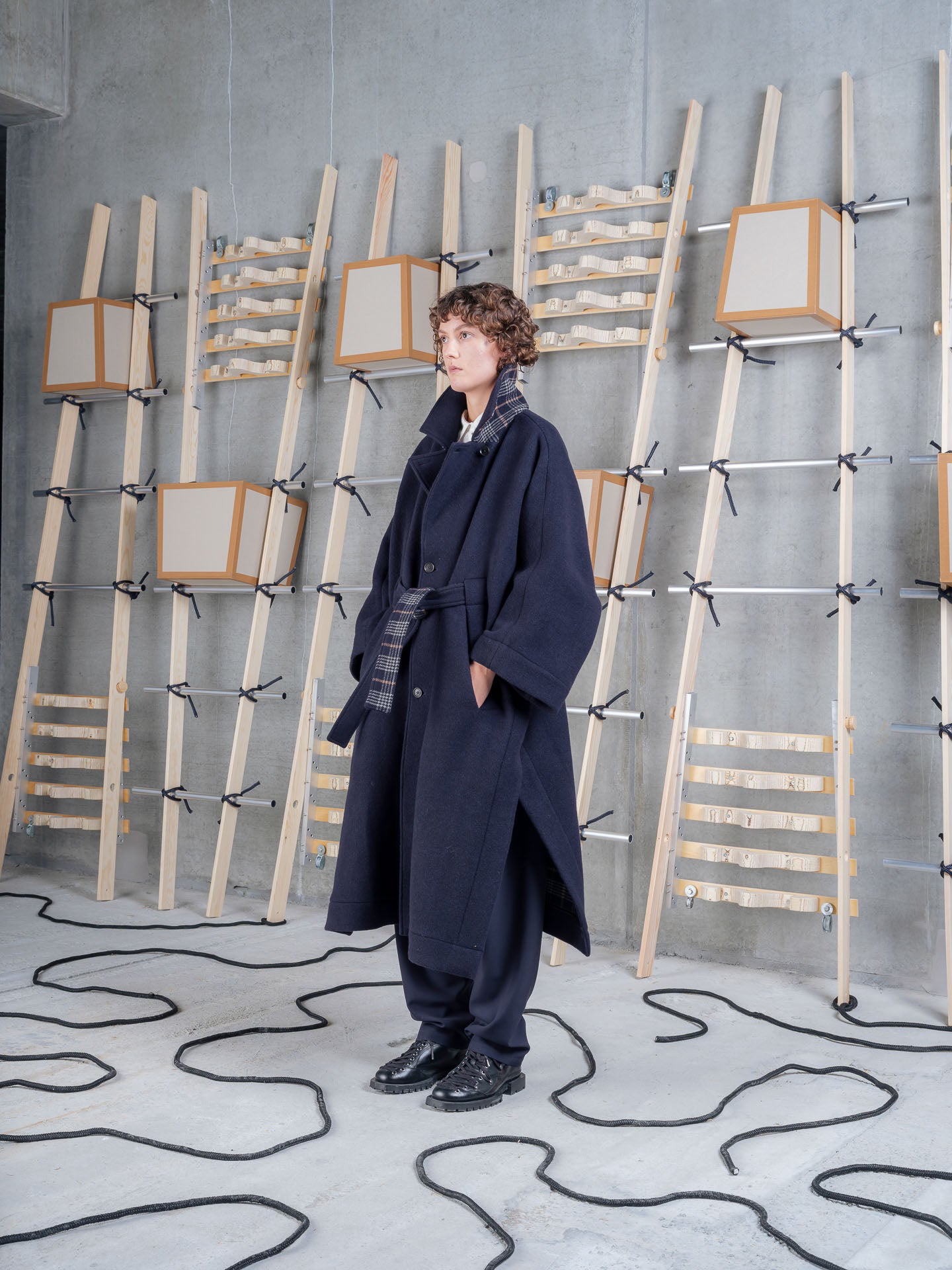 Model wearing Henrik Vibskov Toadcoat in Navy Duffle side view