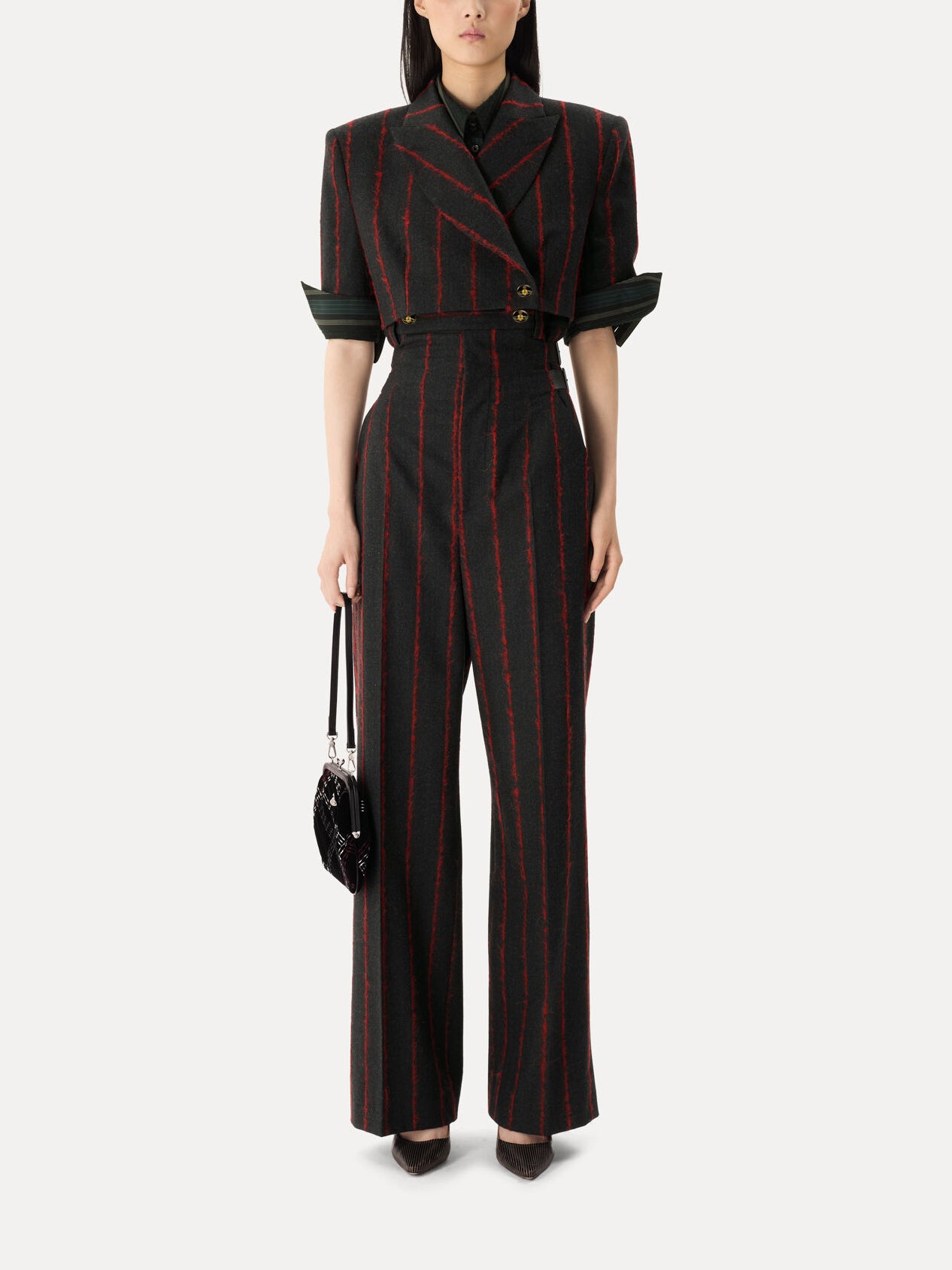 Model wearing Vivienne Westwood Cut Off One Button Jacket in charcoal and red stripe with cropped tailored fit, short sleeves and matching trousers