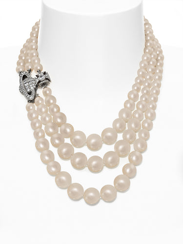 Three row pearl necklace with orb-shaped pendant and clasp on white background.
