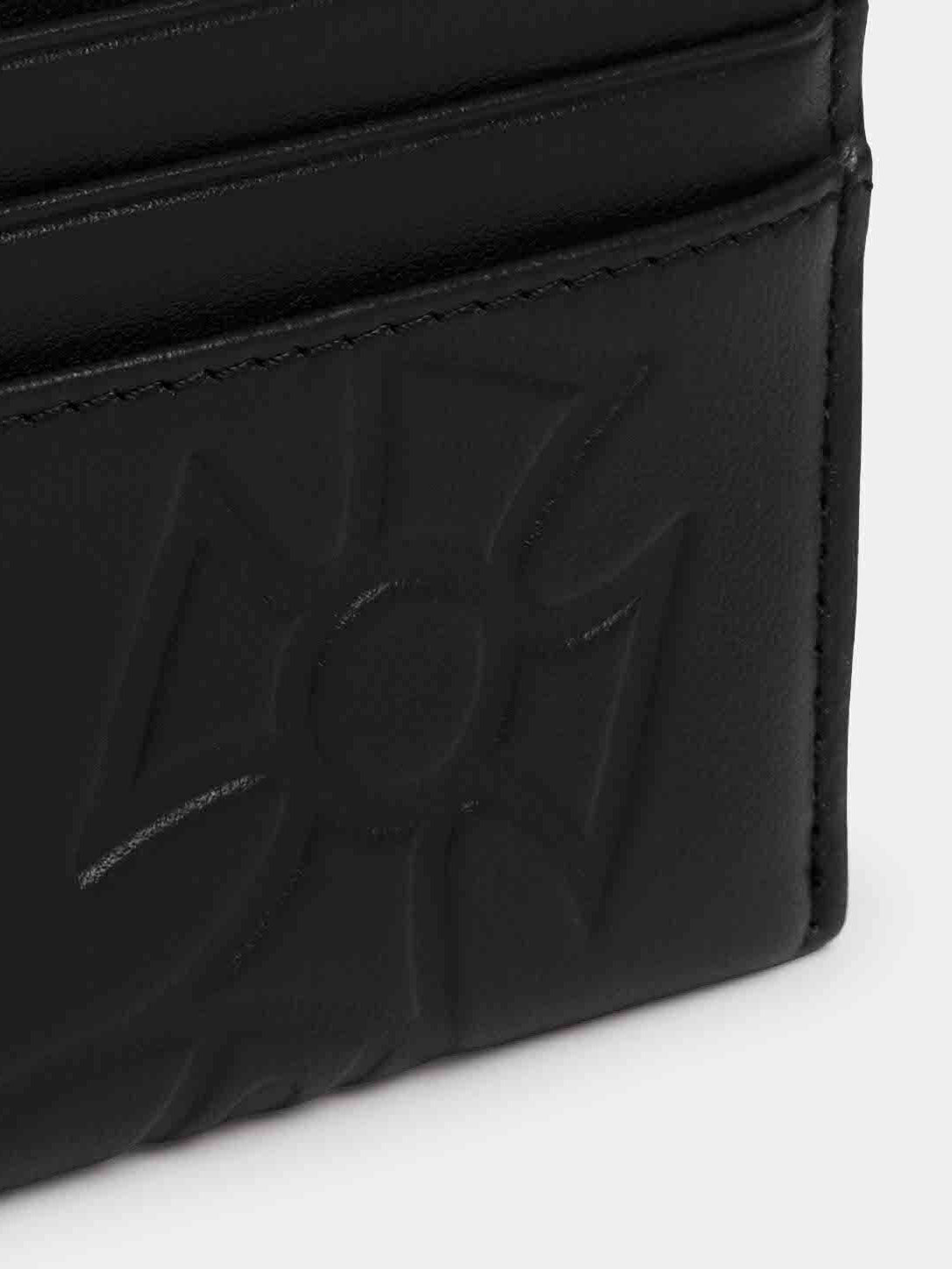 Close-up of Vivienne Westwood Slim Card Holder in black showing embossed orb logo, soft leather texture and stitched card slot detail