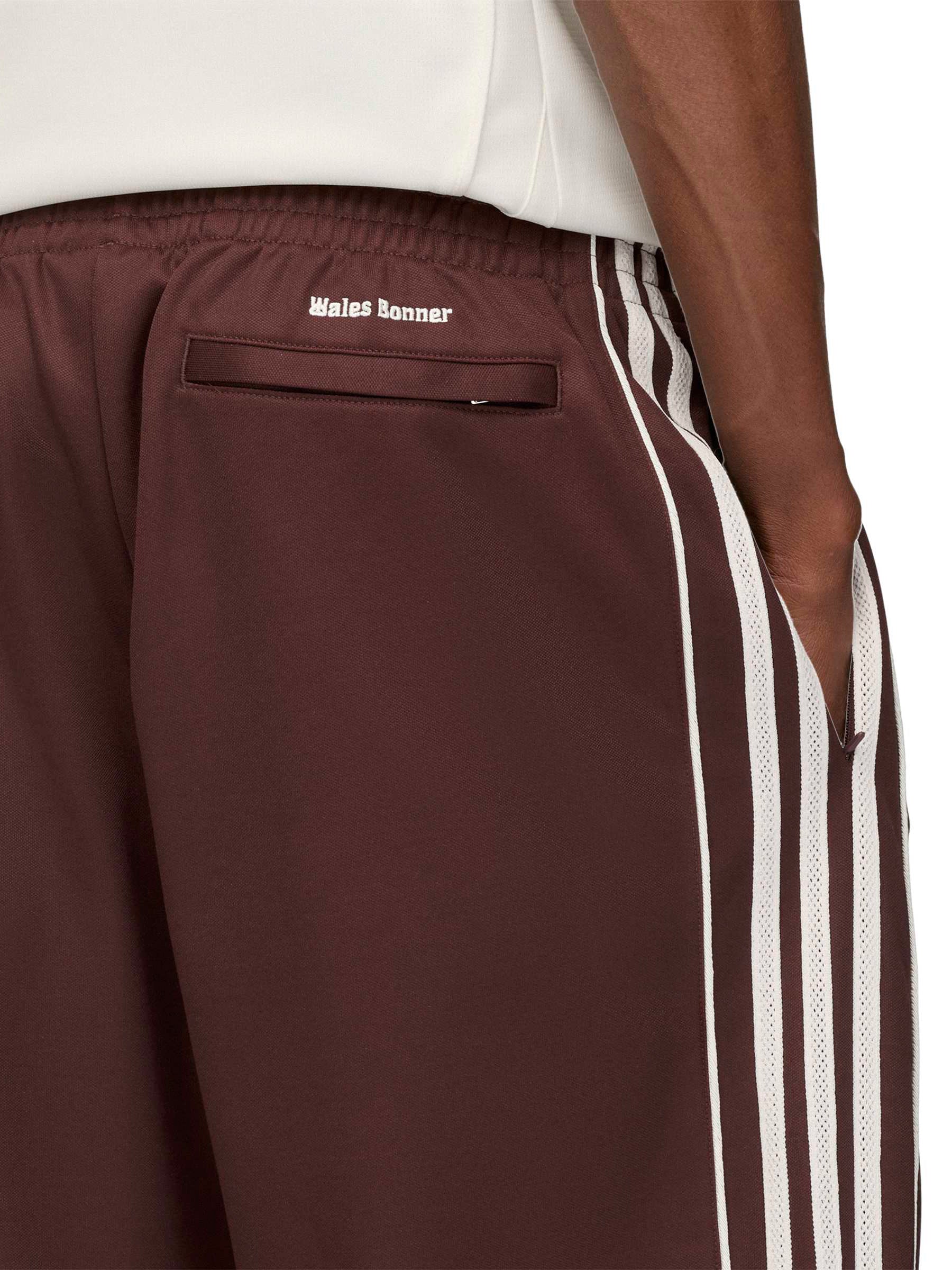 Close-up of Wales Bonner co-branded label and burgundy contrast trim on the Track Pants in Shadow Brown – Wales Bonner x Adidas SS26