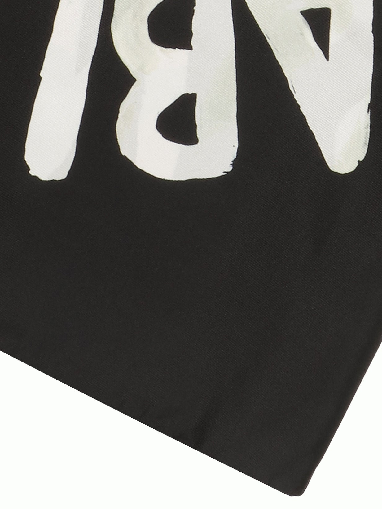 Close-up of black scarf with sunflower illustration from Walter Van Beirendonck