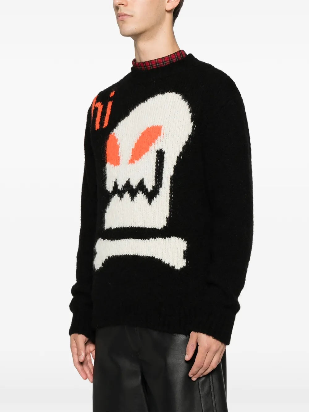 Side profile of the black knitted sweater with skull illustration from Walter Van Beirendonck on a white background.