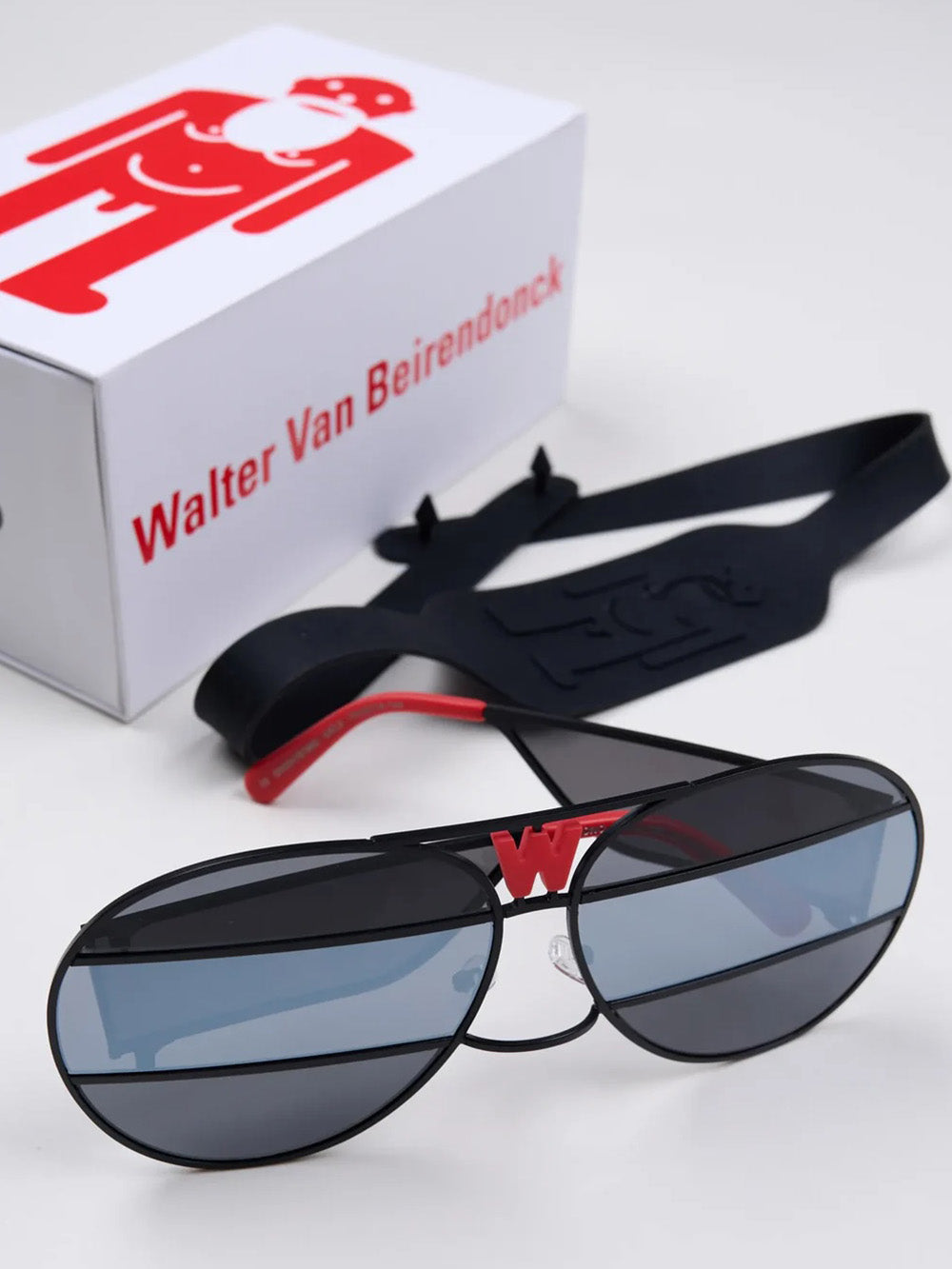 Walter Van Beirendonck x Komono Brutal Pilot sunglasses, styled with branded sports strap and Walter Van Beirendonck presentation box