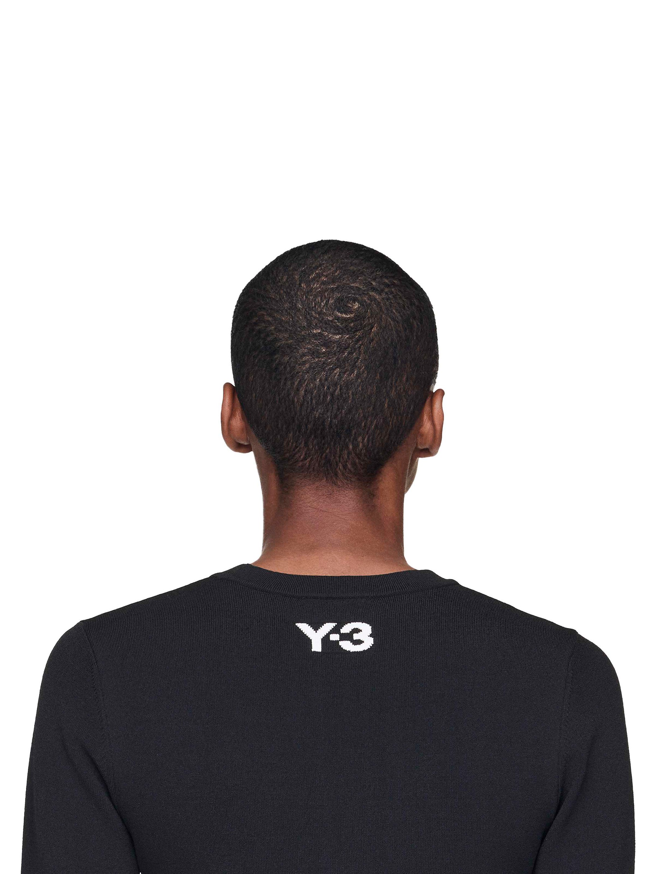 Person wearing a black Y-3 shirt on a white background