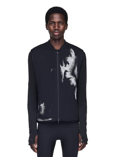 Person wearing a black vest with white abstract design on a white background