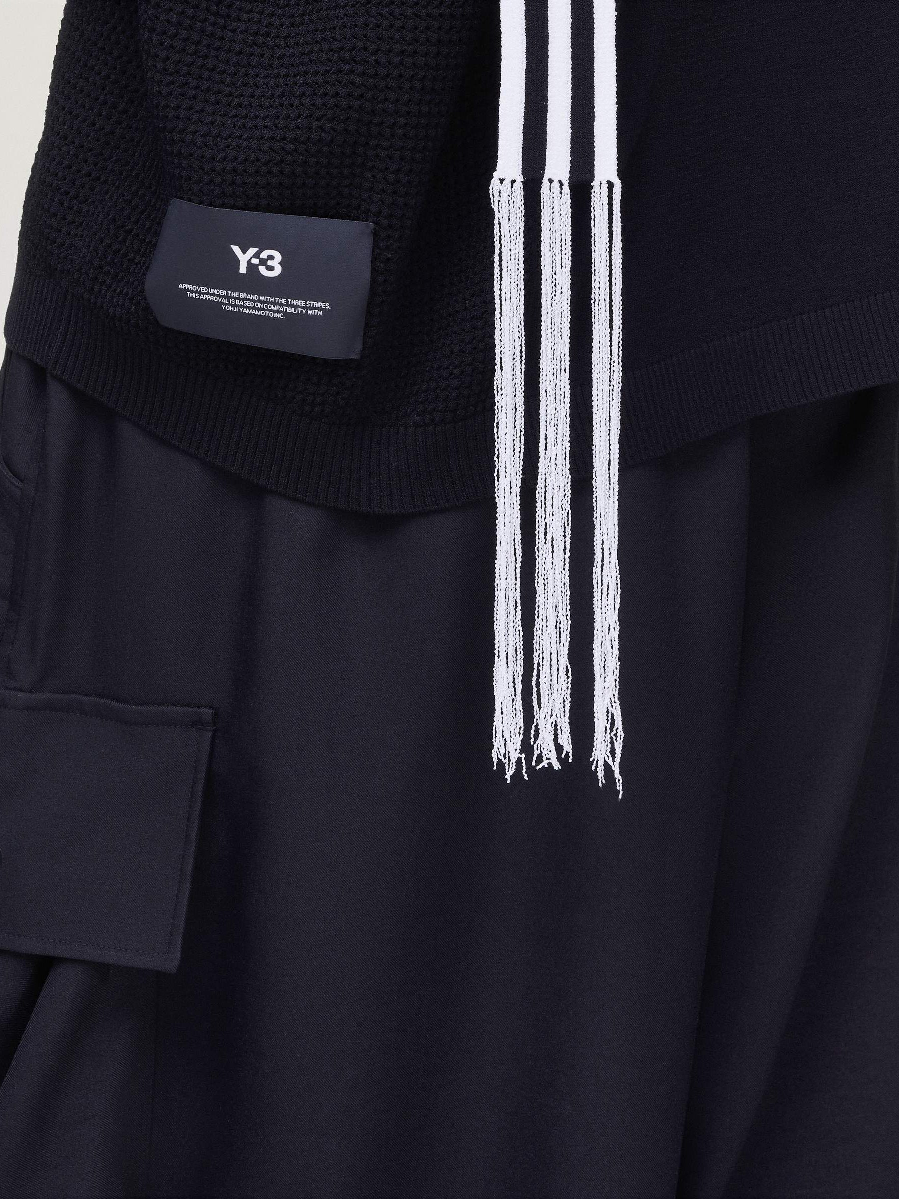 Detail close-up of the Y-3 Knit Top in Black worn on a model, highlighting the knit texture and premium single jersey finish.
