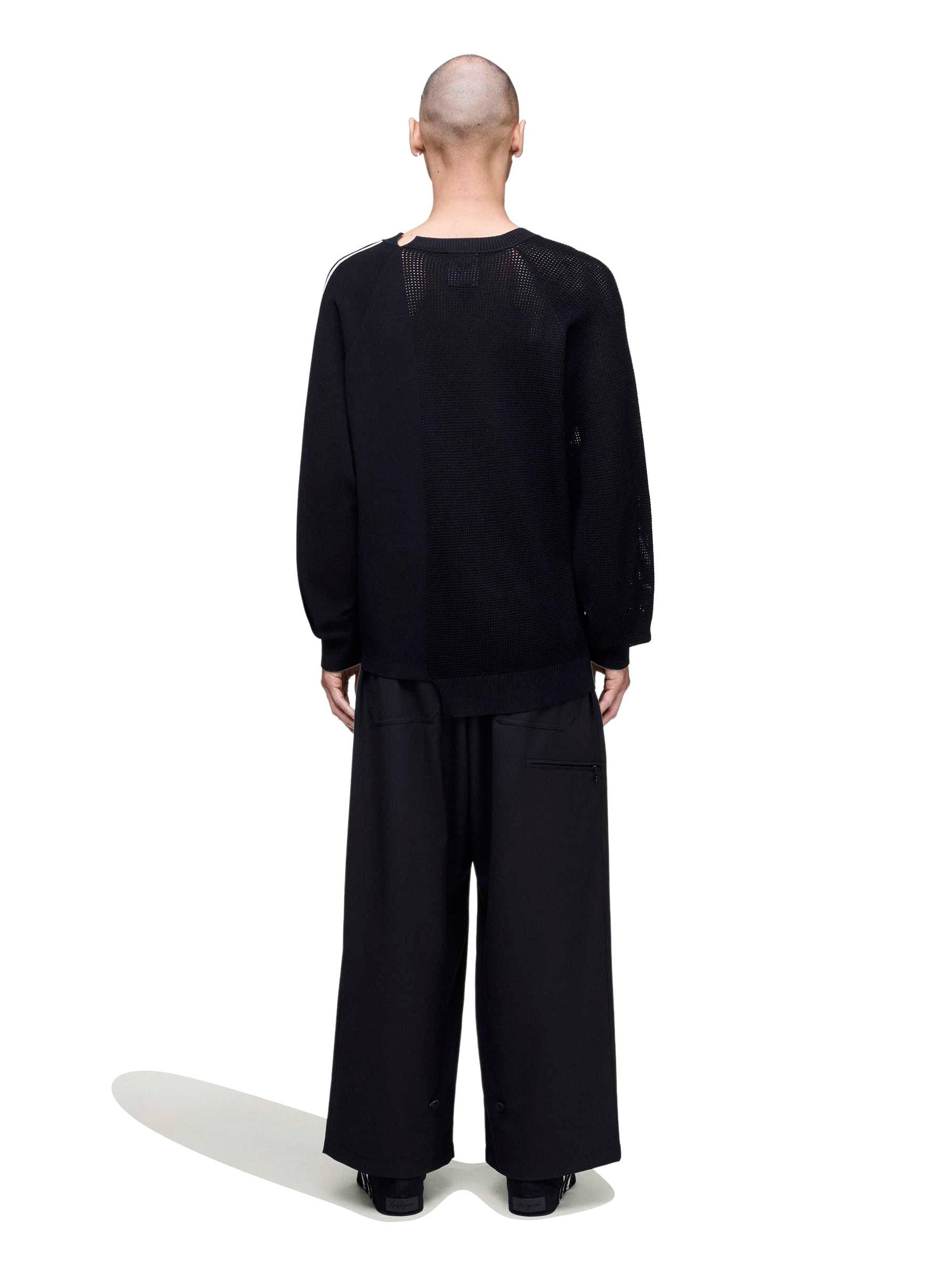 Back view of a male model wearing the Y-3 Logo Knit Sweatshirt in Black, showing the loose fit and smooth knit construction.