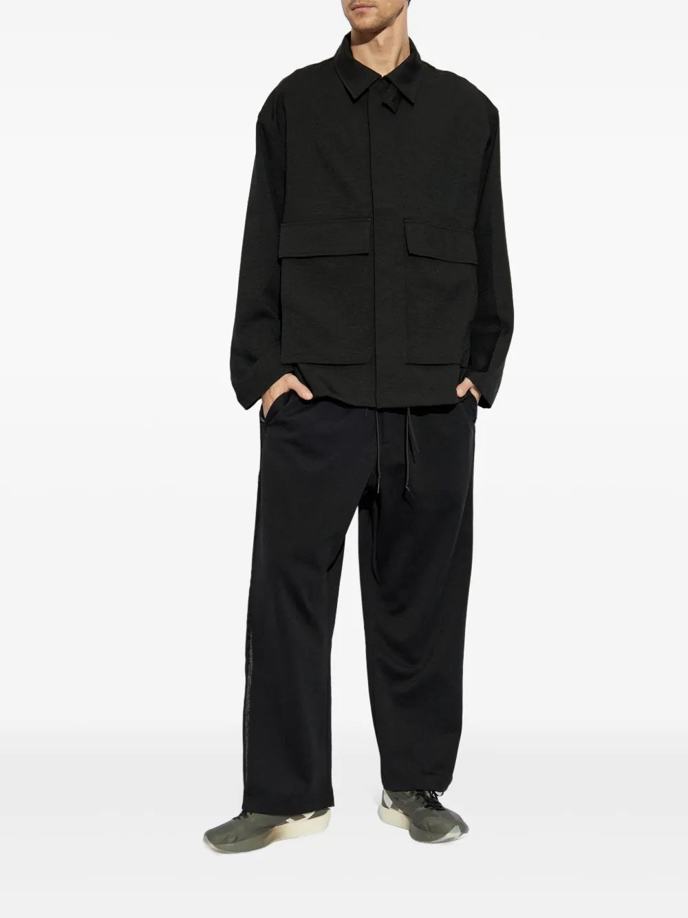 Person wearing a black outfit on a white background