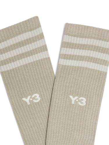 Close-up of the front of the Y-3 Stripes High Socks in Light Brown, highlighting the 3-Stripes cuff, embroidered Y-3 logo, and knit texture.