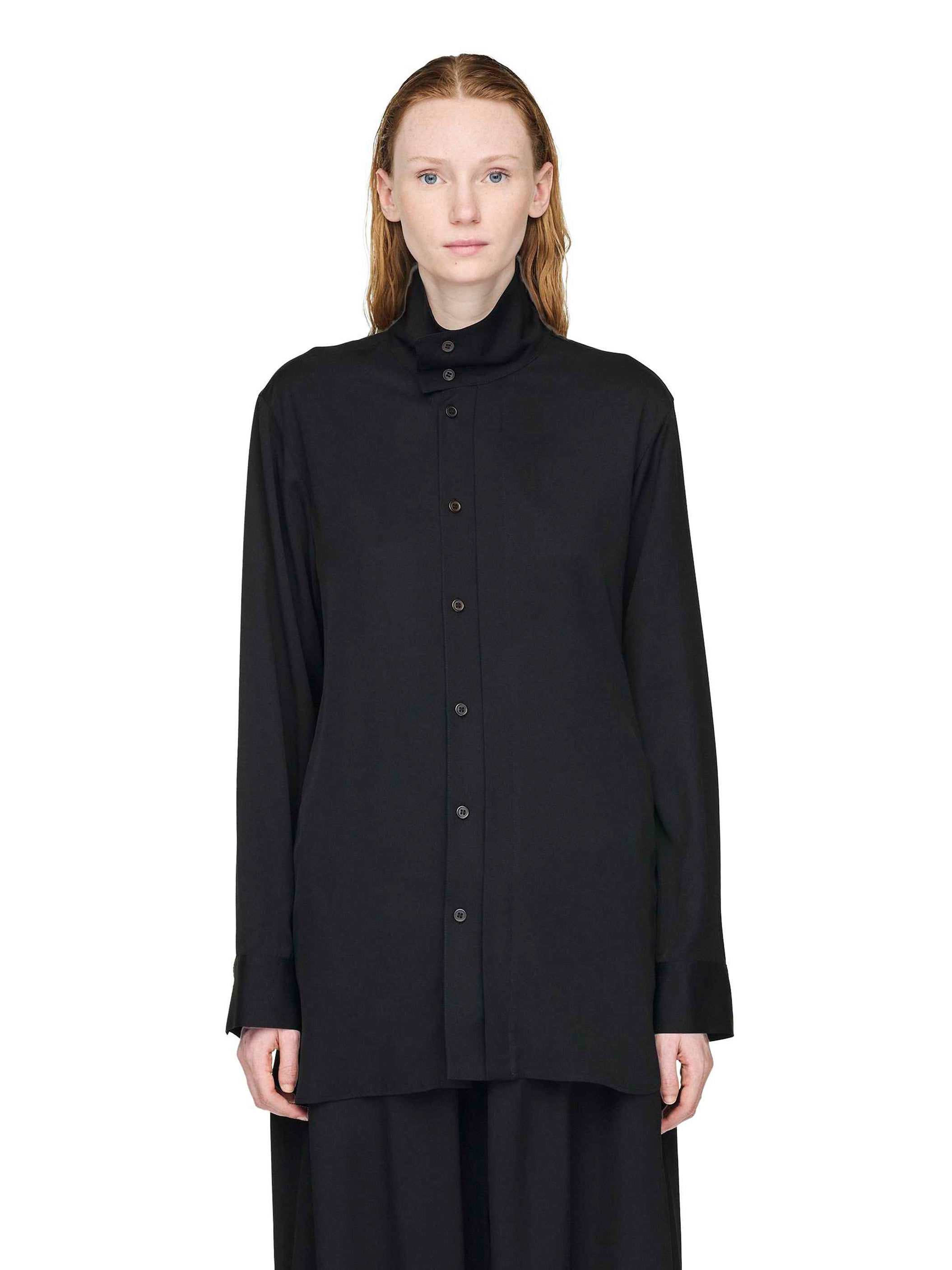Person wearing a black shirt with a high collar on a white background