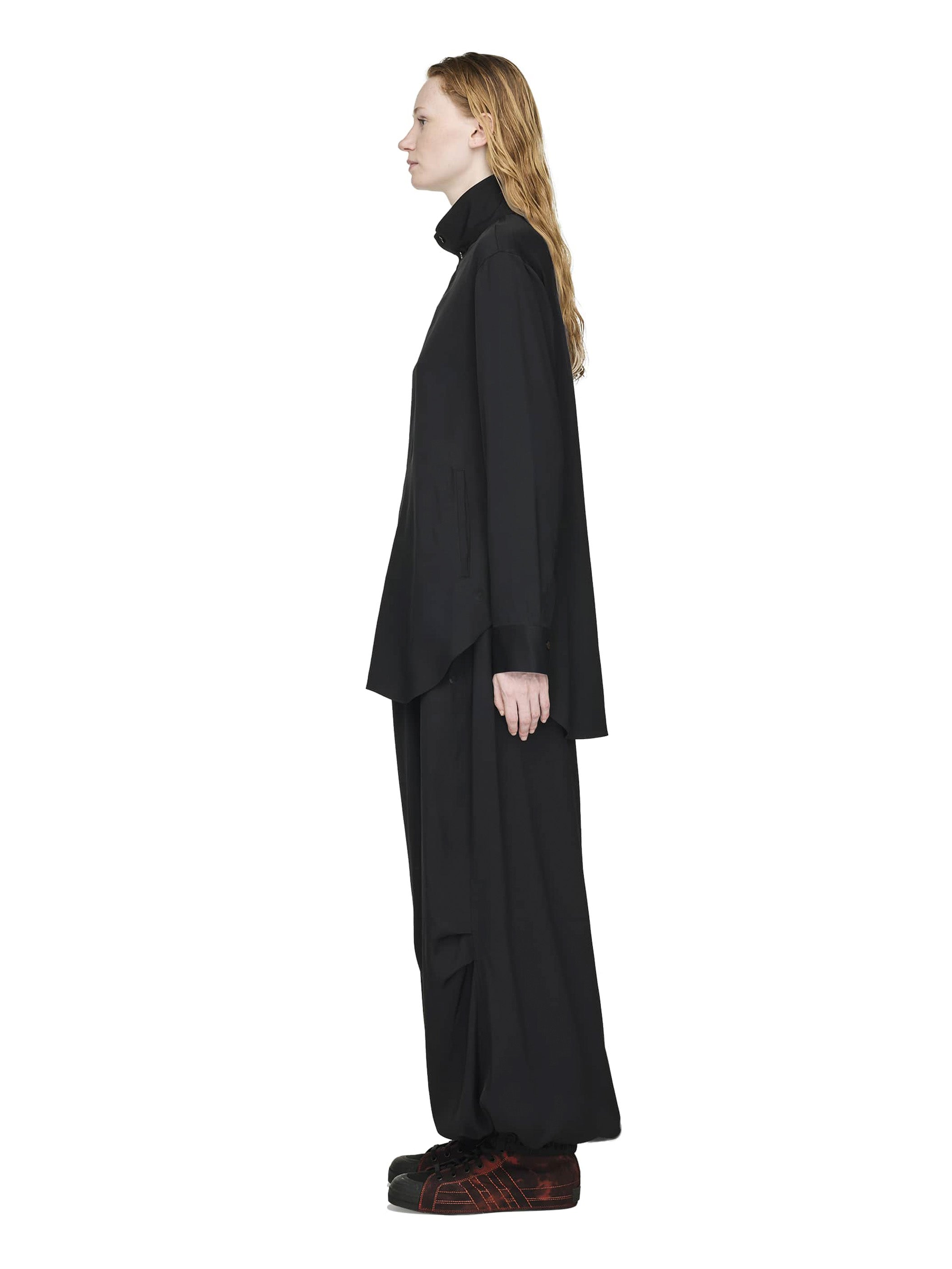 Person wearing a black outfit on a white background