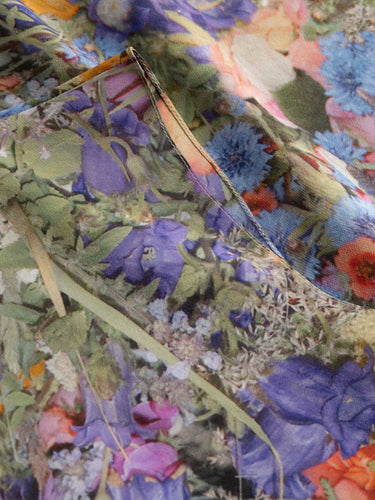 Asym Top in Print G by Anntian, closeup of organic silk fabric showing richly detailed all-over floral print with cornflowers, poppies, roses and wildflowers in blues, purples, oranges and pinks, Spring/Summer 2026