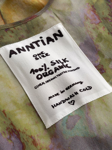 Close-up of the Anntian Big Dress showing the multicolour abstract print and the Anntian brand label at the neckline.