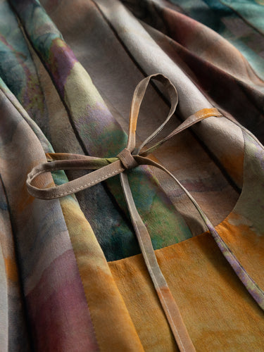 Detail close-up of the silk Big Dress highlighting the fluid texture, abstract pattern, and adjustable drawstring waist.