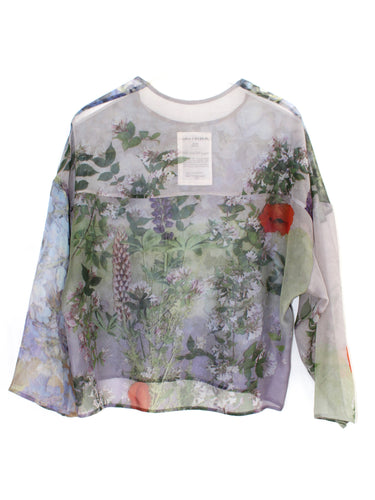Anntian Chiffon Silksweater in Print R, a loose-fit semi see-through sweater in a multicolour floral print with blue tones, round neck, and long sleeves, shown flat from the back on a white background