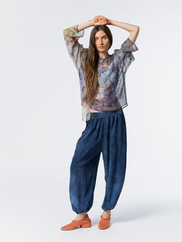 Front view of model wearing the Anntian Chiffon Silksweater in Print R, a loose-fit semi see-through chiffon sweater in a multicolour floral print with blue tones, round neck, and long sleeves