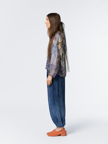Side view of model wearing the Anntian Chiffon Silksweater in Print R, highlighting the loose silhouette and semi see-through chiffon fabric in a multicolour floral print with blue tones